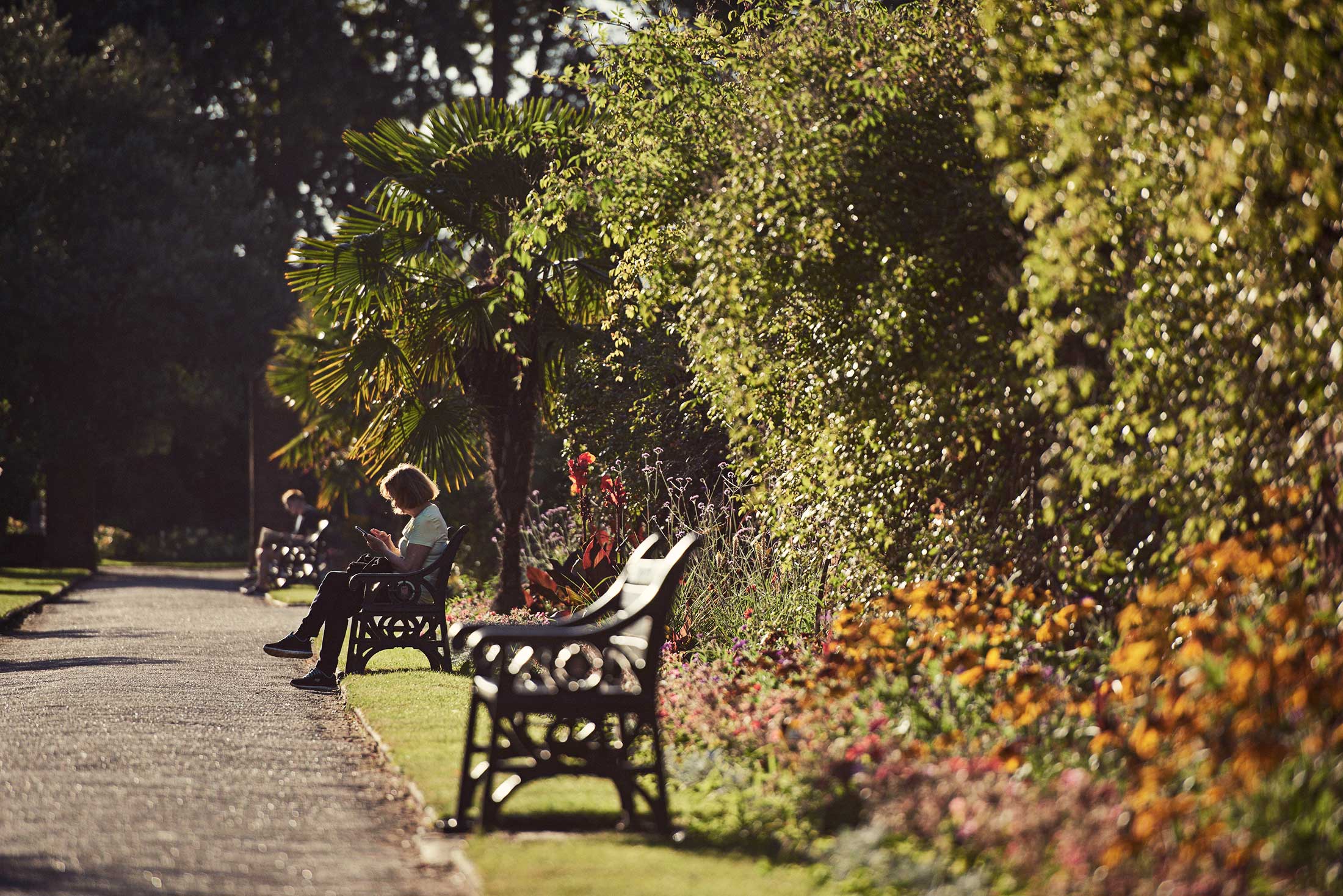 People sat on benches in gardens - Colchester - Beresfords Estate agents - Essex