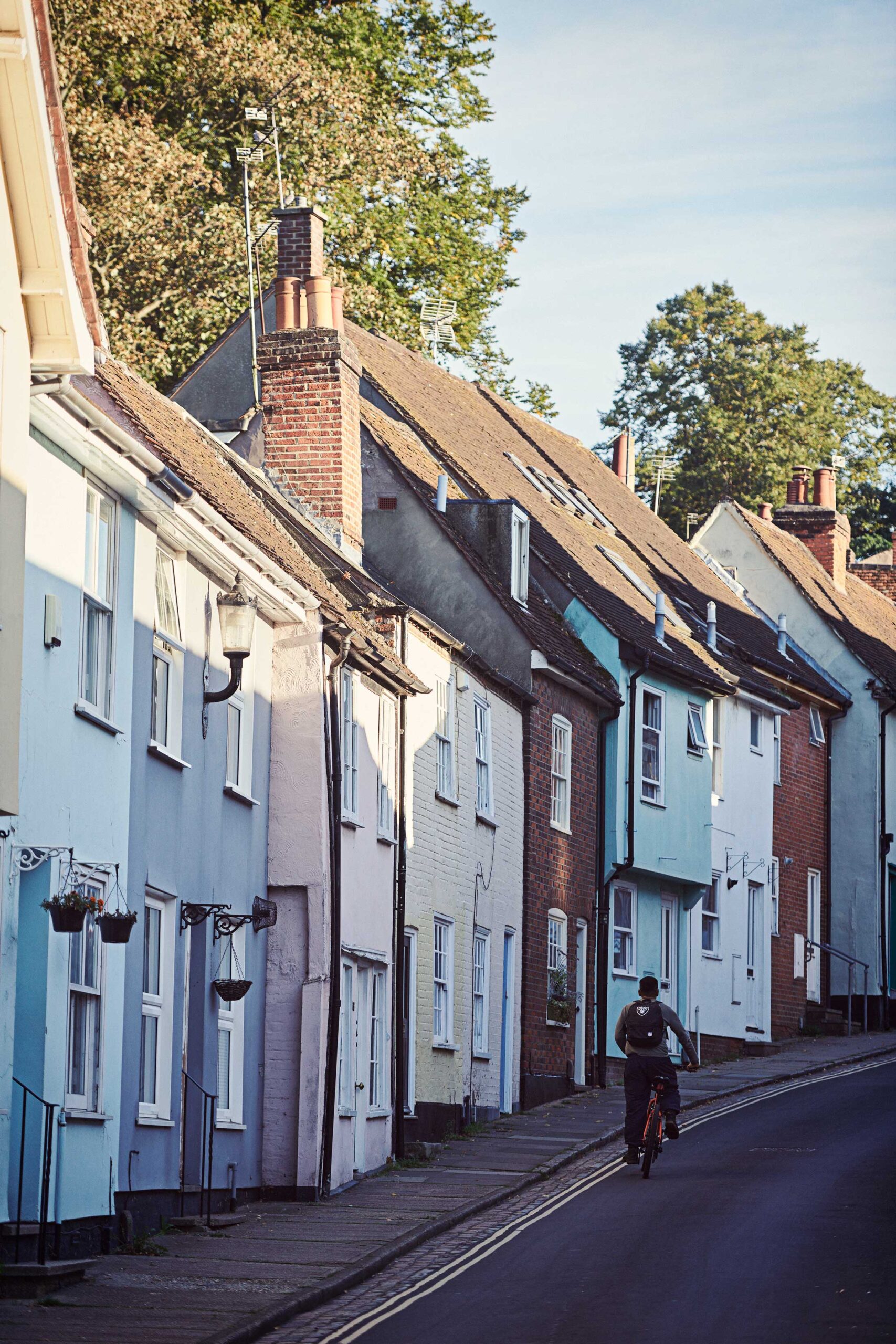 Man cycling by colourful houses - Colchester - Beresfords Estate agents - Essex