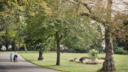 Family walking by trees in park - Ilford - Beresfords Estate agents - Essex